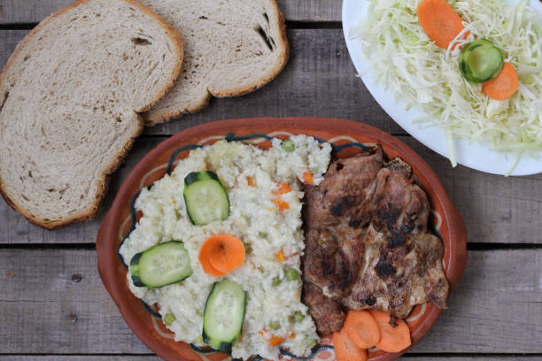 istock Risotto with chiken meat and salad 885481618