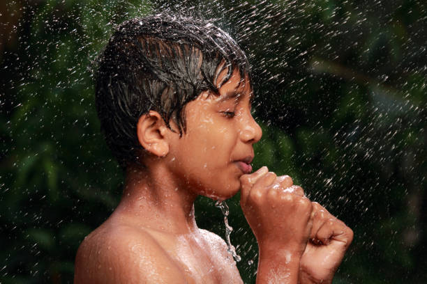 A boy plays with water in the outdoor