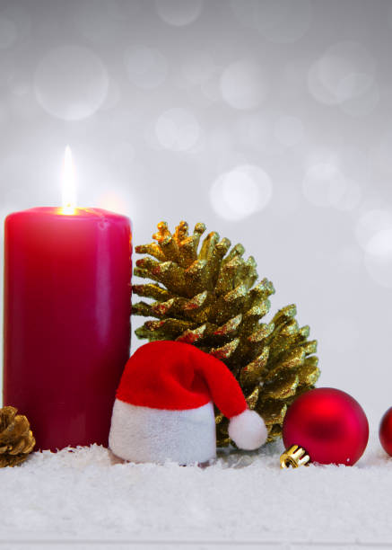 istock Christmas background with Advent candle and Santa Claus hat 885510216