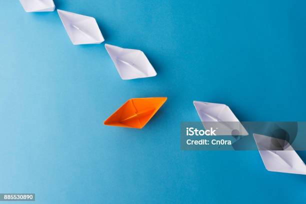 Paper Boats On Blue Background Stock Photo - Download Image Now - Standing Out From The Crowd, Individuality, Abstract