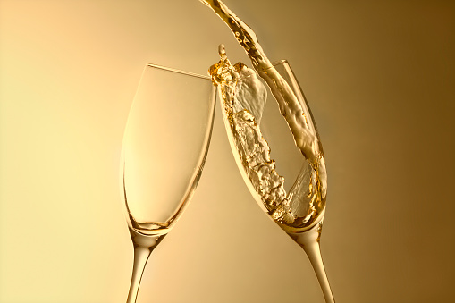pouring champagne into glass, celebrations