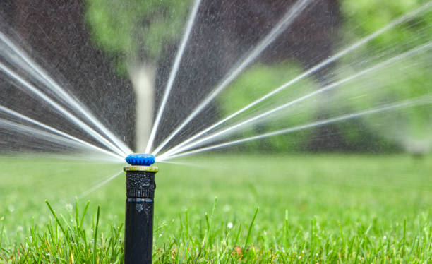 istock automatic sprinkler system watering the lawn on a background of green grass 885534128