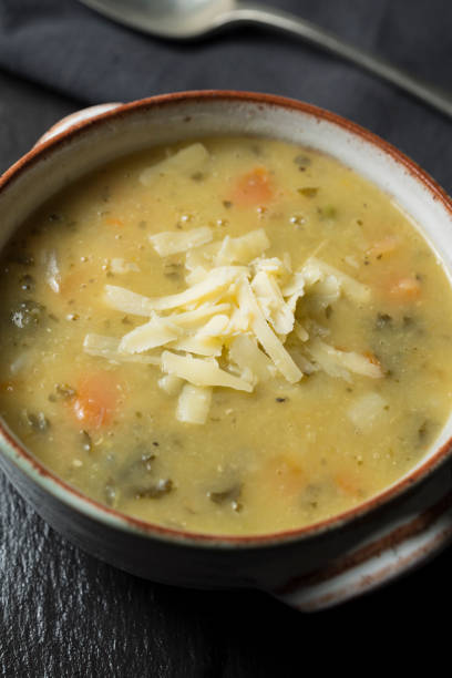 istock Rustic bowl of vegetable soup topped with grated cheese. 885537648