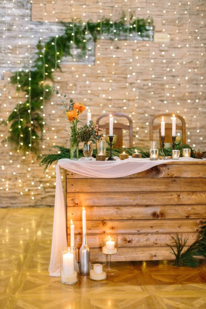 istock restaurant, serving, design concept. space for celebrating holidays decorated with twinkle lights on the walls, various plantes like branches of spruce and bunches of roses 885539778
