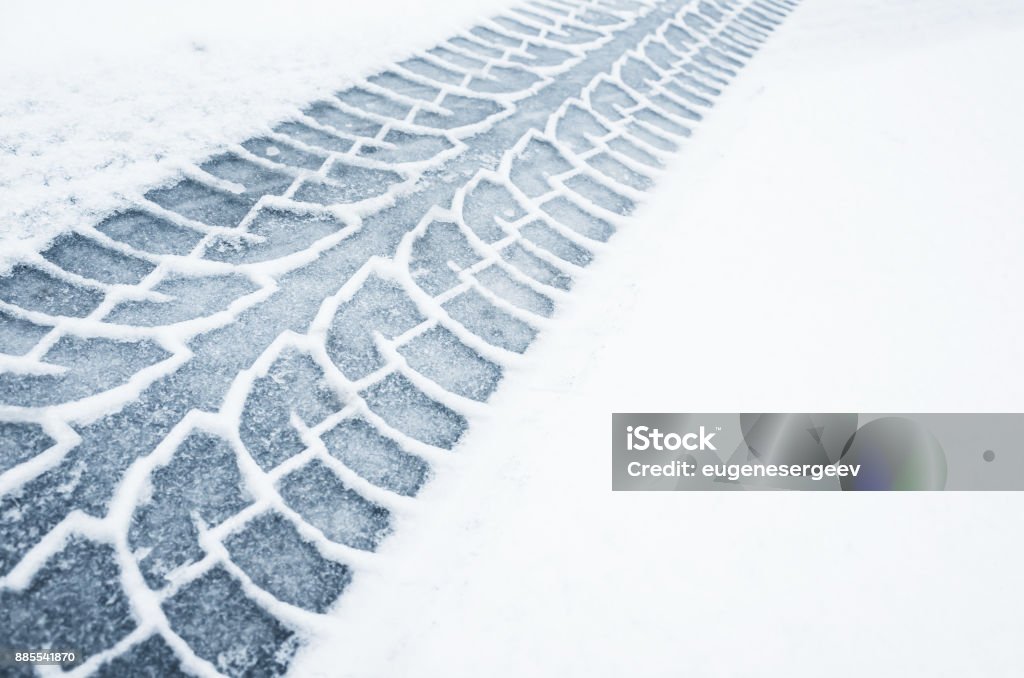 Car track on a wet snowy road, closeup Car track on a wet snowy road, closeup background photo texture Snow Stock Photo