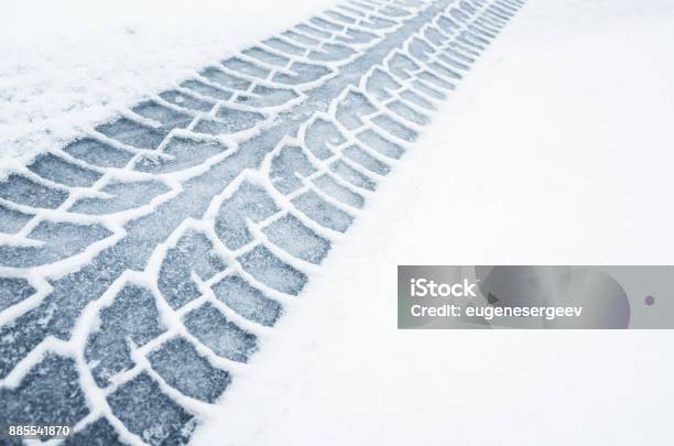 Car Track On A Wet Snowy Road Closeup Stock Photo - Download Image Now - Snow, Winter, Road