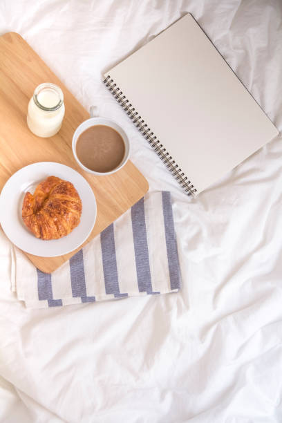 istock Bed breakfast with coffee cup, croissants and milk in bed 885542068