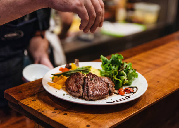 istock Stir fried beef steak served with vegetable side dish and salad topping with balsamic dressing. 885548508