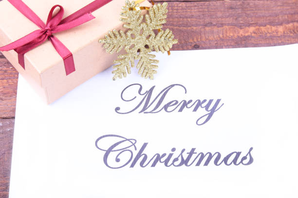 istock Text merry christmas on paper with many balls and gift boxes 885548624