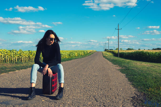 Woman hitchhiking on the road