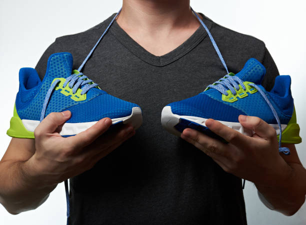 istock Man holding modern running shoes 885552276