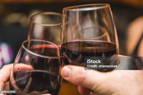 Three Wine Glasses Touching Stock Photo - Download Image Now - Pinot Noir Grape, Celebratory Toast, Red Wine