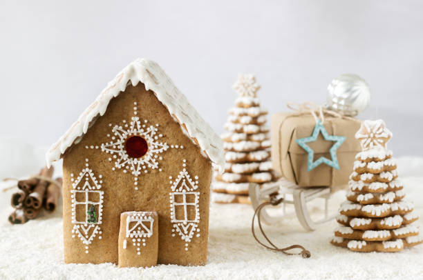 istock Gingerbread house and gingerbread tree on a light background. 885559590
