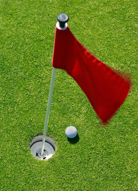 istock Golf ball on green with flag. 885571314