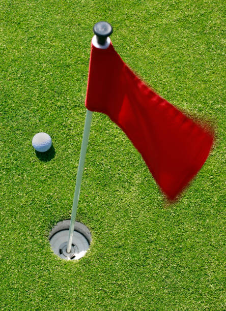 istock Golf ball on green with flag. 885571316
