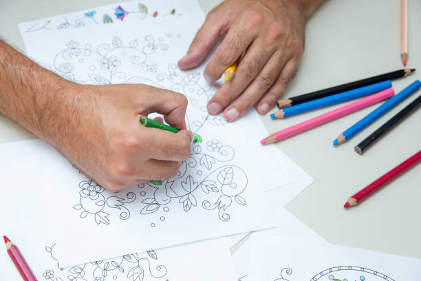 istock Close Up Mature Man Hands Coloring 885574424