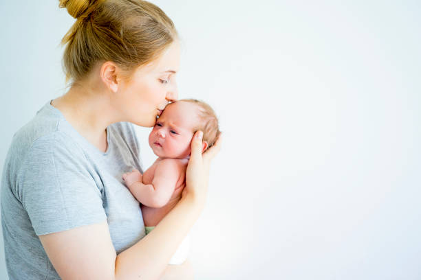 A portrait of a mother with her newborn baby