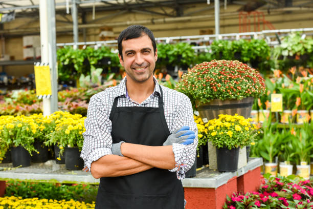 istock Male Florist working at a nursery 885577646