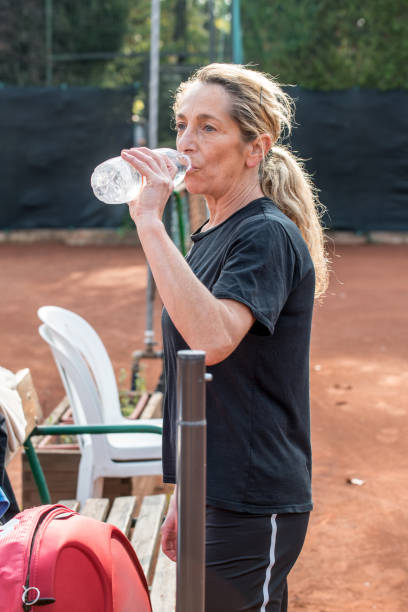 istock Recreational Tennis Player Drinking Water 885587076