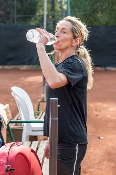 istock Recreational Tennis Player Drinking Water 885587086