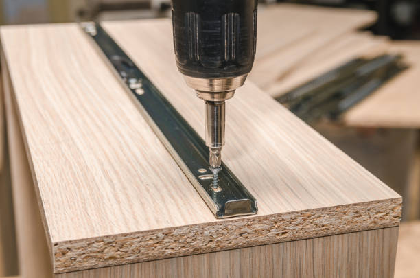 istock Assembling of furniture closeup 885592890