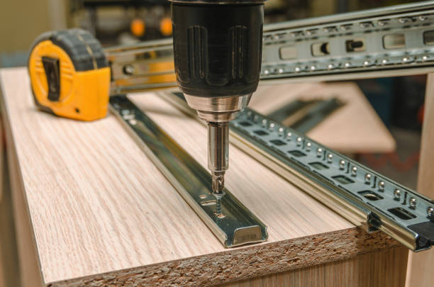 istock Assembling of furniture closeup 885592892