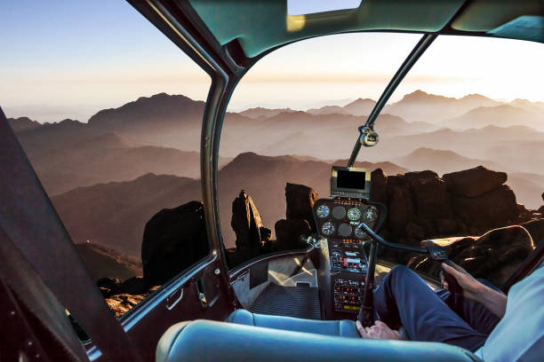 Mount Sinai Helicopter Helicopter cockpit with pilot arm and control console inside the cabin in aerial view of the holy summit of Mount Sinai, Aka Jebel Musa, 2285 meters, at sunrise, Sinai Peninsula in Egypt. jebel hafeet stock pictures, royalty-free photos & images