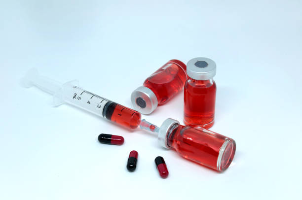 istock Medical syringe pill and red vials, isolated on white background. 885606410