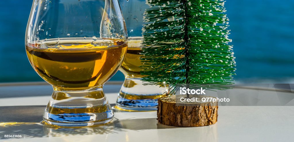 single malt whisky  in the glass with decorative Christmas tree, luxurious tasting glass single malt whisky  in the glass with decorative Christmas tree, luxurious tasting glass, tasty set Alcohol - Drink Stock Photo