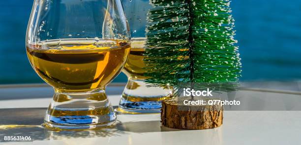 Single Malt Whisky In The Glass With Decorative Christmas Tree Luxurious Tasting Glass Stock Photo - Download Image Now