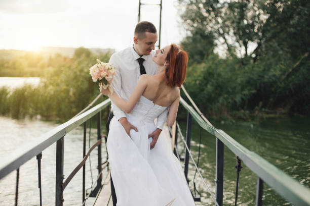 istock bride and groom are standing on the bridge 885650780
