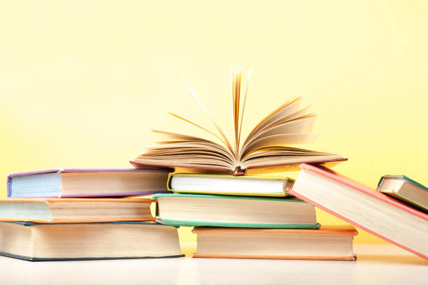 istock Open book, hardback books on wooden table. Education background. Back to school. Copy space for text. 885653076