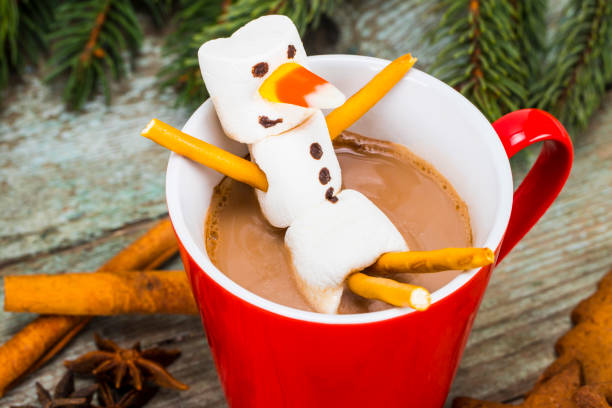 istock Red mug with hot chocolate with melted marshmallow snowman 885656046