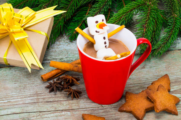 istock Red mug with hot chocolate with melted marshmallow snowman 885656054