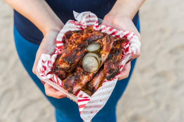 Pork barbecue baby ribs at a street food market Pork barbecue baby ribs at a street food market food festival stock pictures, royalty-free photos & images