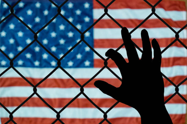 A symbolic representation of immigrants and the united states of america This is an emotional picture about the immigration policies of the united states immigrant stock pictures, royalty-free photos & images
