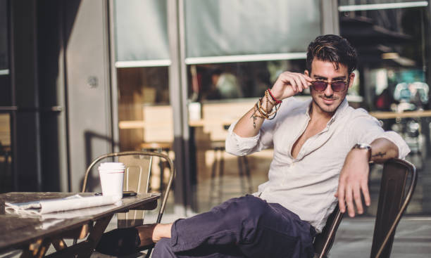 istock Attractive man sitting in coffee shop 885665400