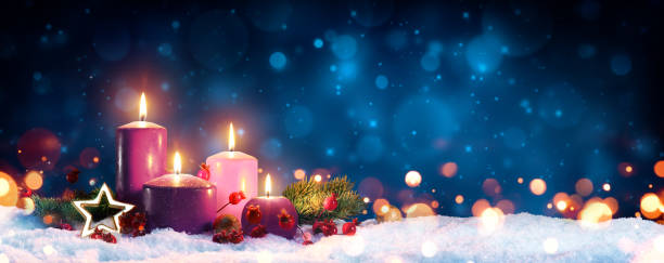 Four Advent Candles In Christmas Wreath On Snow Three Purple And One Pink As A Religious Symbol advent candles stock pictures, royalty-free photos & images