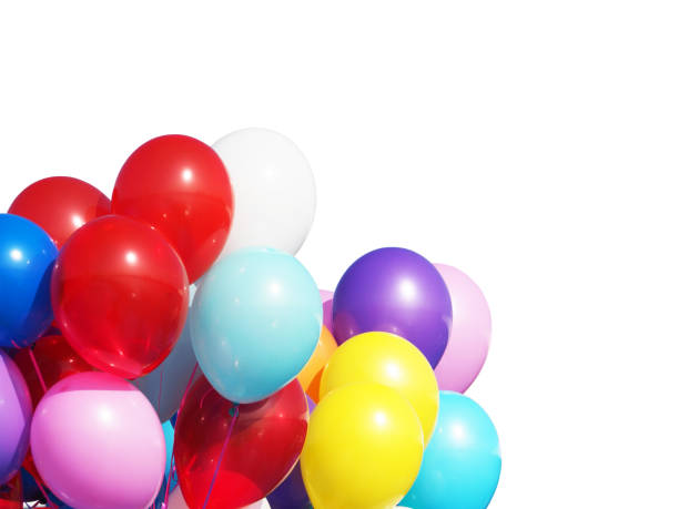 istock Bunch of multicolored balloons under bright sunlight isolated on white background. The concept of a holiday, objects design. White, blue, yellow, red, pink inflatable balls filled with helium 885682468
