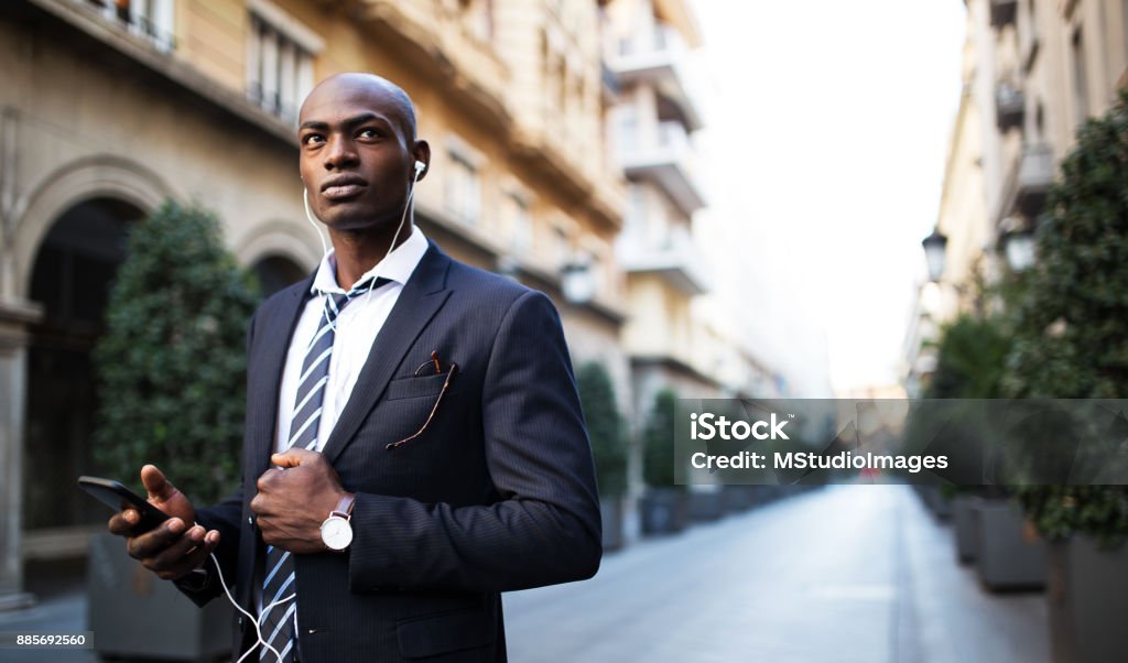 Serious African businessman Handsome African businessman using mobile phone on the street Nigeria Stock Photo