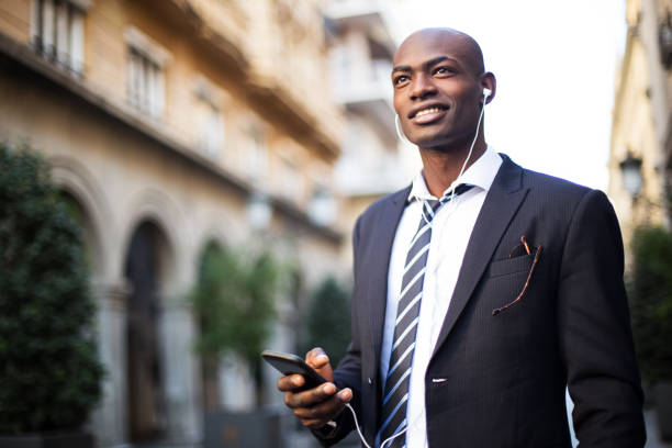 istock Smiling African businissman using mobile phone. 885692626