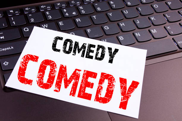 istock Writing Comedy text made in the office close-up on laptop computer keyboard. Business concept for Stand Up Comedy Microphone Workshop on the black background with copy space 885704388