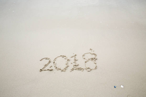 istock Happy New Year 2018, lettering on the beach, 2018 885712194