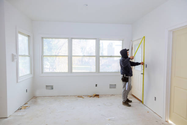 istock Carpenter brad using nail gun to moldings on doors, framing trim, 885726502