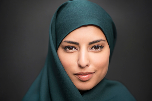 Portrait of a beautiful smiling muslim woman wearing hijab.
