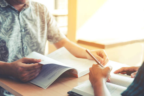 istock University studying friends studying and reading a books in classroom 885744930