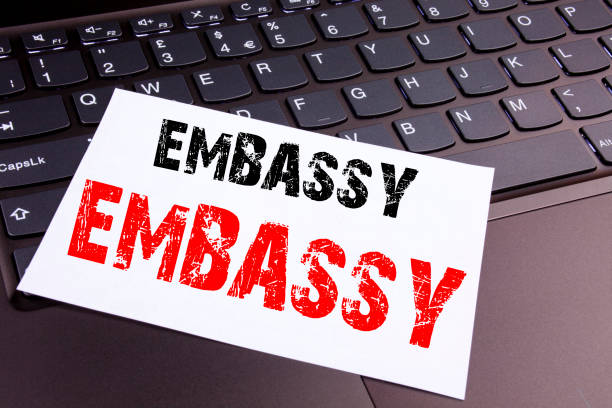 istock Writing Embassy text made in the office close-up on laptop computer keyboard. Business concept for Tourist Visa Application Workshop on the black background with copy space 885752138