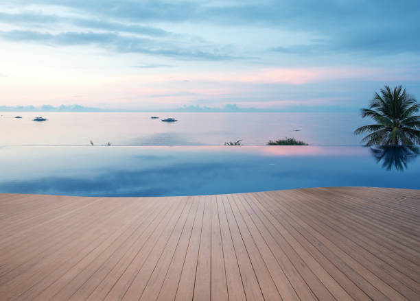 деревянная терраса рядом с бесконечным бассейном - swimming pool infinity pool patio sea стоковые фото и изображения