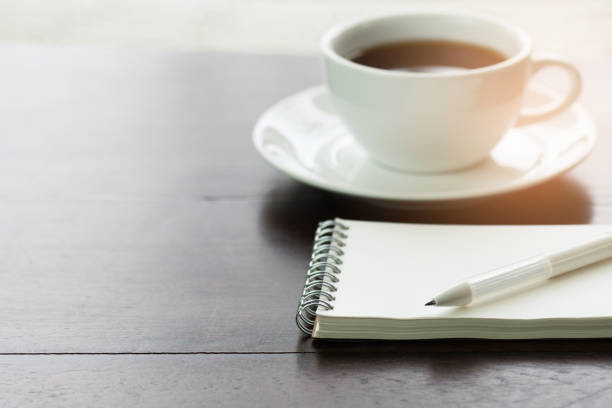 istock Blank notepad with pen for writing message on wooden table 885756736