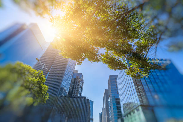 istock Business towers and Green leaves 885767320